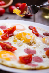 Fried eggs with sausage slices