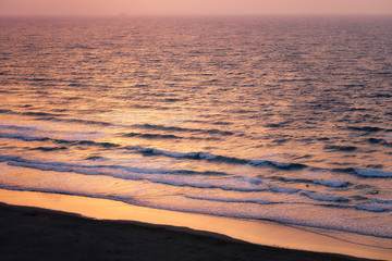 beach with waves at sunset
