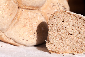 Organic home made bread with flax seeds and rural background