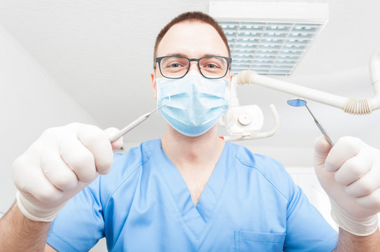 Dentist ready to make a consult holding tools