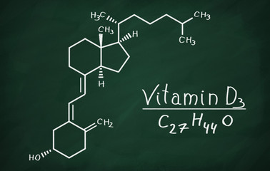 Structural model of Vitamin D3 molecule on the blackboard.