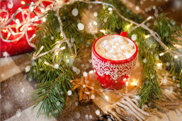 cup of hot cocoa with marshmallow with Christmas decorations at home, Christmas tree on background,...