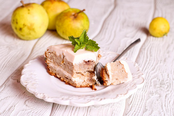 A slice of apple pie on a plate with cream