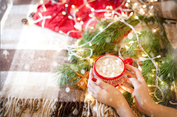 cup of hot cocoa with marshmallow with Christmas decorations at home, Christmas tree on background,...
