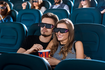 Young happy couple having a date at the cinema