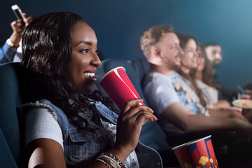 Beautiful African woman enjoying a movie