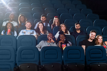 Cheerful friends together at the movie theatre
