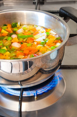 Vegetable soup cooked on gas stove