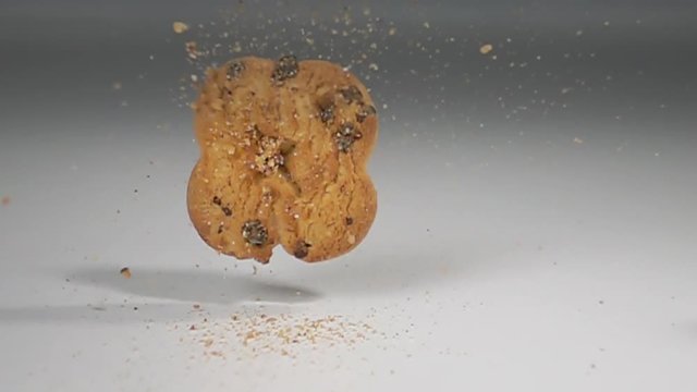 cookie biscuit falling on white table super slow motion