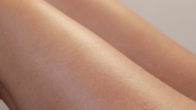 Slow motion preventing dry skin on female body close-up 1920X1080 HD footage - Treatment on woman legs with hydrating cream slow-mo anti-aging 1080p FullHD video 