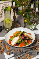 Pumpkin salad with lettuce, cherry tomatoes, and lemonade