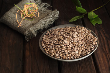 A plate with brown beans with a napkin