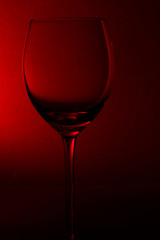 empty glass for wine on red back
