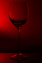 empty glass for wine on red back