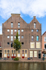Warehouses on quayside of Old Rhine canal in old town of Leiden, South Holland, Netherlands