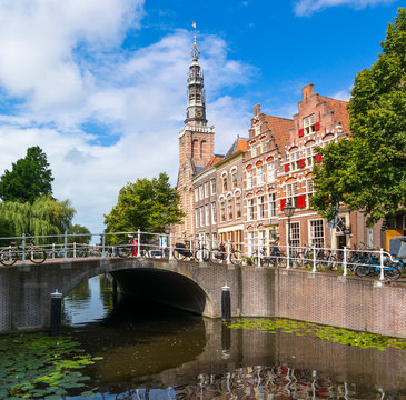 Canal, bridge, church tower and houses Steenschuur, Leiden, Netherlands