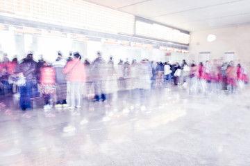 Blurred background : people queuing to buy a public transport au