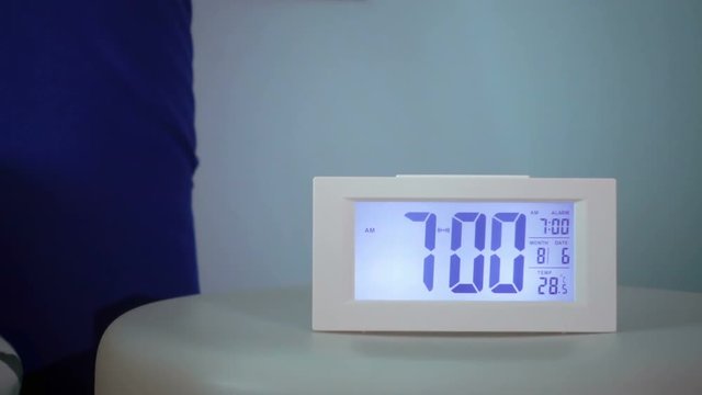 hand punching alarm clock slow motion