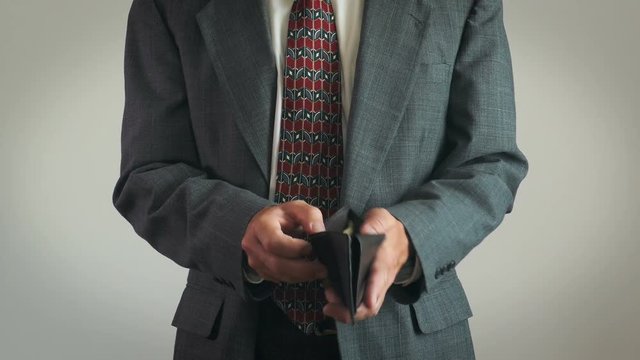 Businessman Opens Wallet To Give Out Money