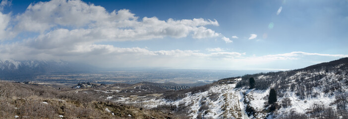 large panoramic view of snow covered mountains and valley in Uta