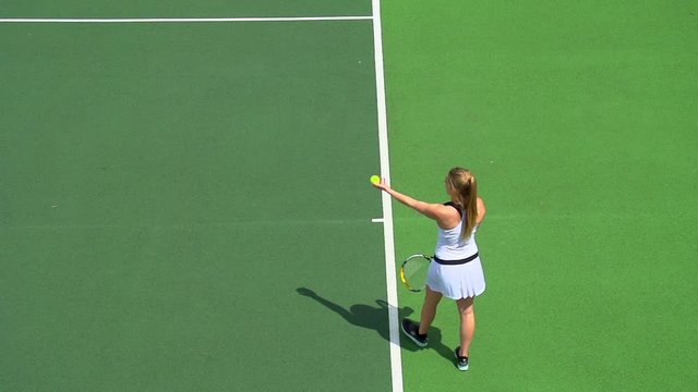 Young Woman tennis serve.