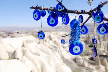 Evil eye charms hang from a tree in Cappadocia, Turkey