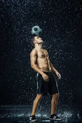 Foto op Canvas Water drops around football player © master1305