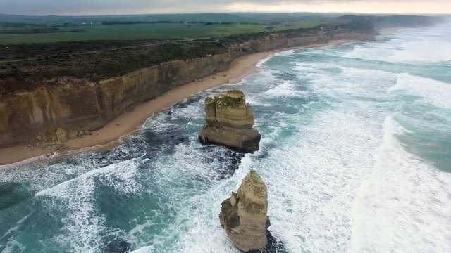 Drone flight over Gog and Magog rock formations towards the Great Ocean Road. Victoria, Australia