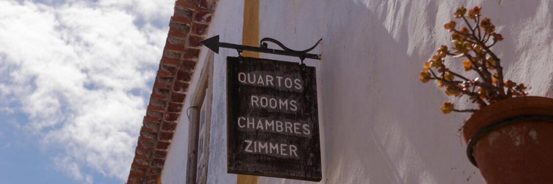 Sign Reading Room In Different Languages On The Wall