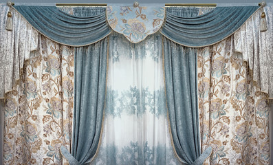 Luxury interior is decorated in the palace style. Curtains, pelmet and tulle from natural materials