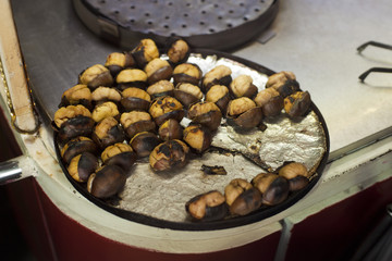 The iron plate full of chestnuts in the shell