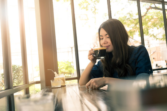 young asian women drinking coffee at the cafe on the morning