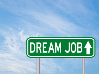 Green transportation sign with dream job wording and arrow on bl