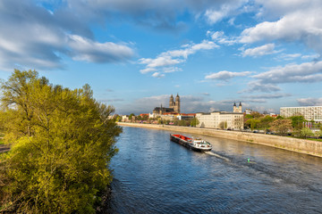 View of Magdeburg with cathedral and river Elbe, bright daylight landscape with blue sky and clouds, Saxony, Germany