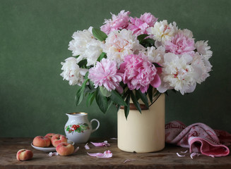 Still-life with a bouquet of pink and white peonies in cans.