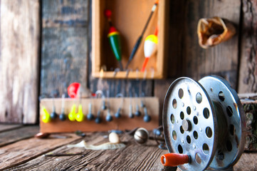 Fishing equipment on vintage wooden background. Selective focus