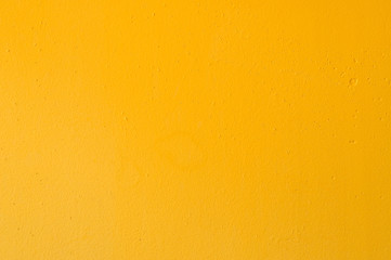 Yellow grunge cement wall for texture background