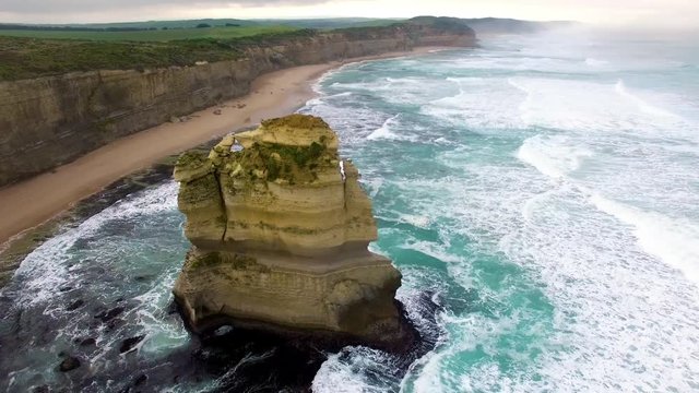 Beautiful cinematic circular movement around Gog and Magog rock formations revealing Twelve Apostles and lookout. Great Ocean Road, Victoria, Australia