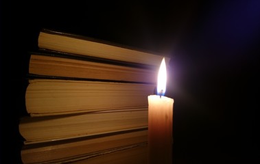 Books and a burning candle