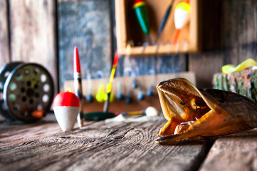 Fishing equipment on vintage wooden background. Selective focus