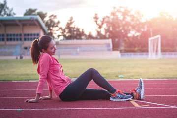 Beautiful woman fitness runner stretching legs before run,worm u