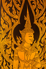 god in Thai style hand painting art golden color on window of the temple