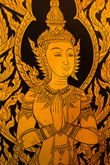 god in Thai style hand painting art golden color on window of the temple
