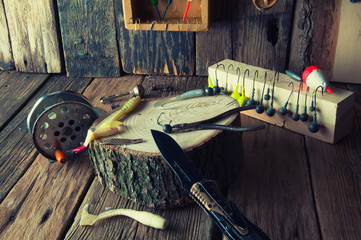 Fishing equipment on vintage wooden background