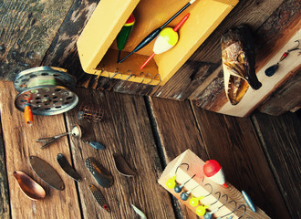 Fishing equipment on vintage wooden background. Top view