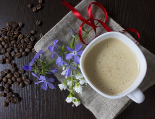 Coffee and spring flowers on old wooden table 