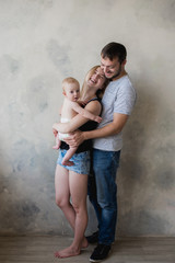 Happy mother, father and daughter playing on the white background,child baby at home