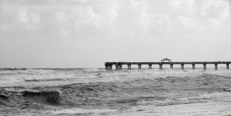 Black and White Seashore Pier With Ocean Waves At The Beach © Alessandra