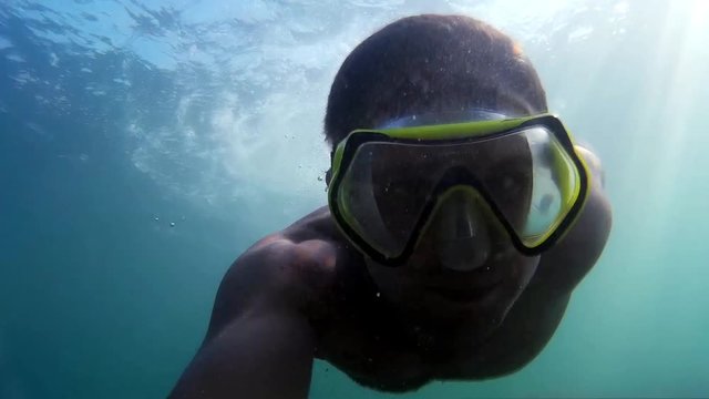 Man swimming underwater. Diving on the Black Sea. Man plunges into the sea.   Diving, man dives and swims under water.  Marine dive, active, bright impressions. Go-Pro video.  
