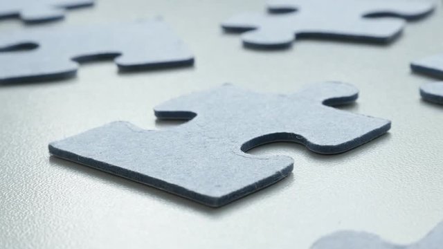 Jigsaw puzzle blue pieces on the table shallow DOF 4K 2160p 30fps UHD tilting footage - Slow tilt over problem solving toys arranged chaotically 3840X2160 UltraHD video 